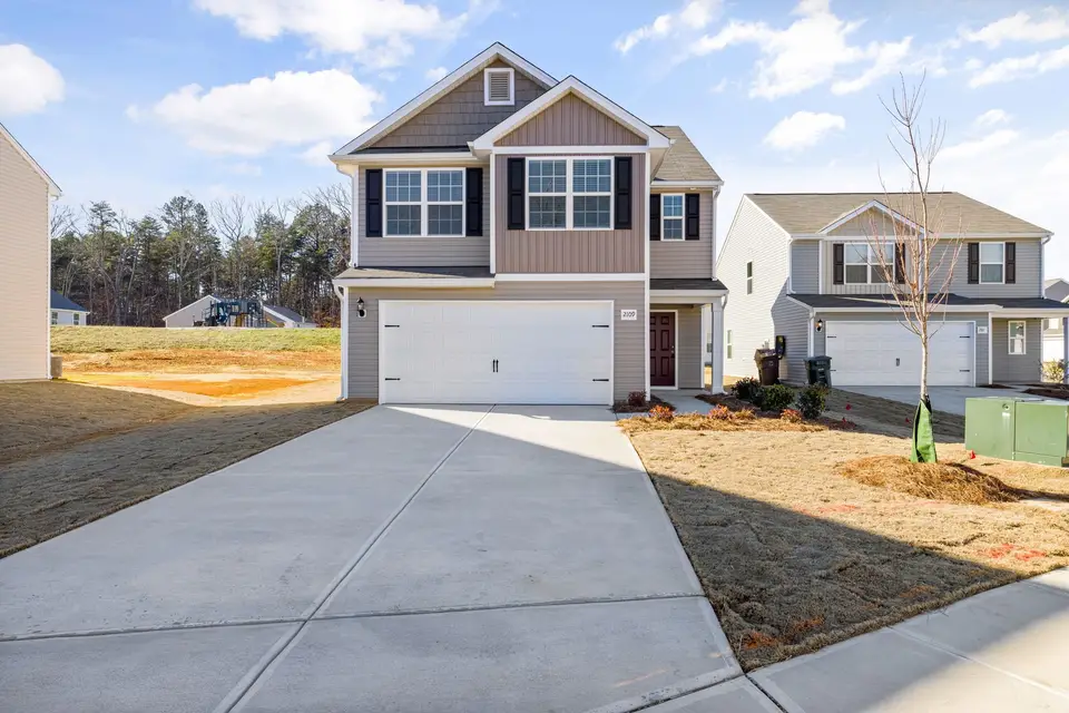 Home with a two-car garage and mature trees