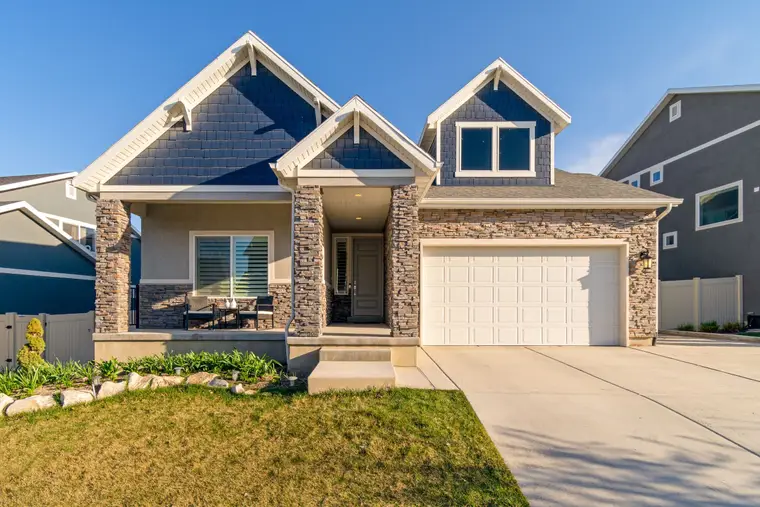 Home with a stone front and gabled roof