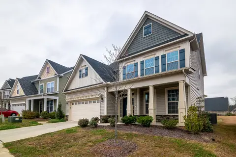 Row of new homes with garages and landscaped lawns