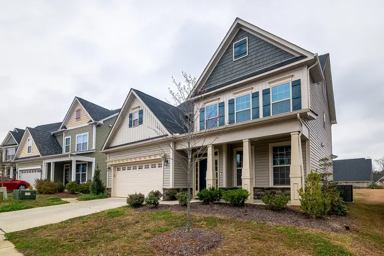 Row of new homes with garages and landscaped lawns